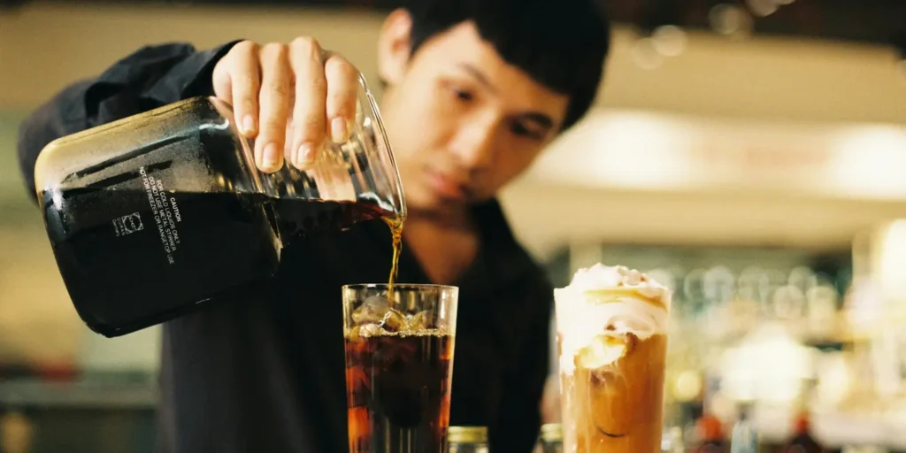 guy pouring coffee ☕ Bold Brews A guide to must-try Vietnamese Coffees where in vietnam blog feat